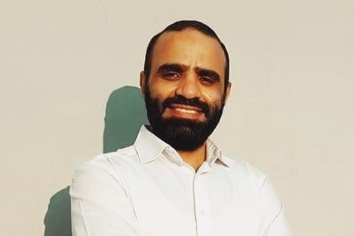 A person with a beard

Description automatically generated