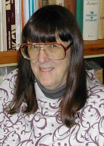 A person with long brown hair wearing glasses

Description automatically generated