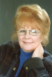 A person with red hair wearing glasses

Description automatically generated