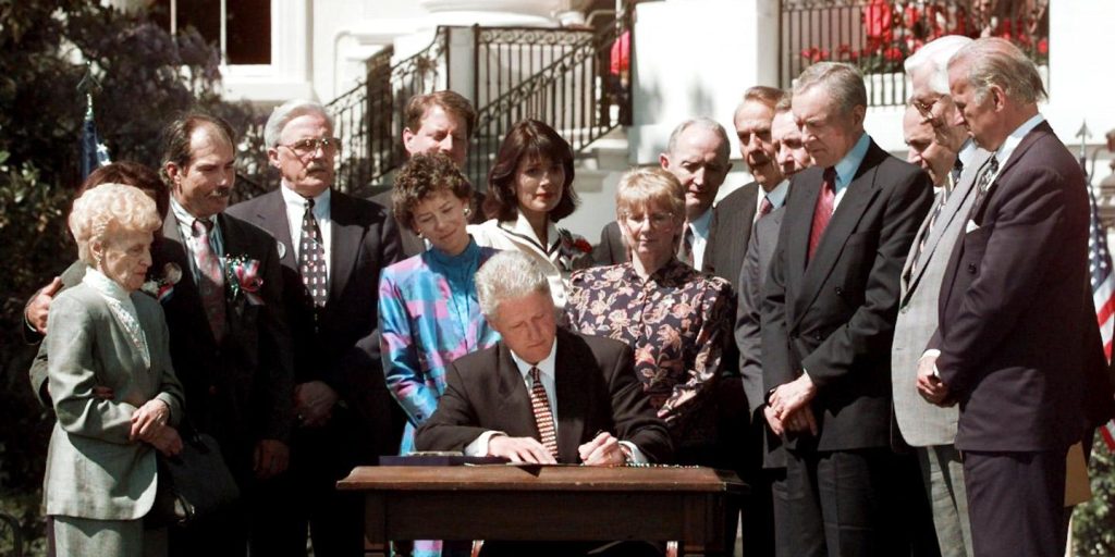 President Clinton signs the Anti-Terrorism Bill during a ceremony Wednesday, April 24, 1996 on the White House South Lawn. The legislation gives federal authorities $1 billion worth of additional tools to fight terrorism at home and abroad. Behind Clinton are victims of terrorist attacks and various government officials. (AP Photo/Doug Mills)