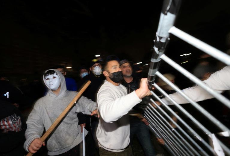 Pro-Israel attackers try to remove barricades at a pro-Palestinian encampment at the University of California, Los Angeles, on May 1, 2024 [David Swanson/Reuters]