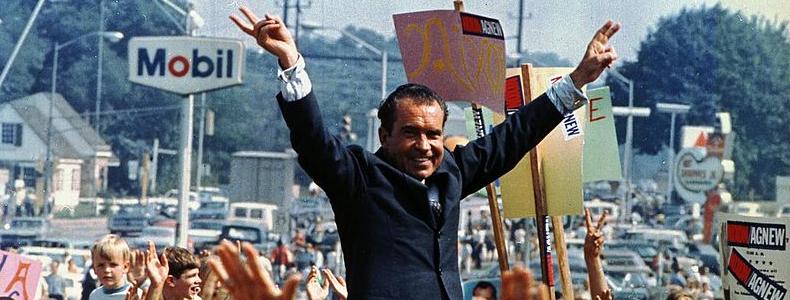 A person holding signs and smiling

Description automatically generated