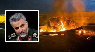 A person in military uniform and a burning car

Description automatically generated