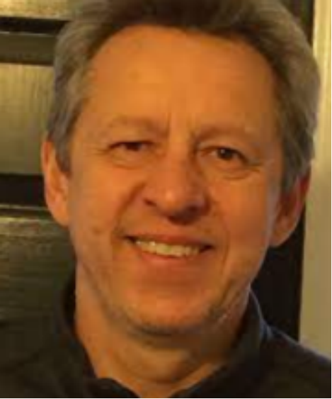 A person smiling at the camera

Description automatically generated
