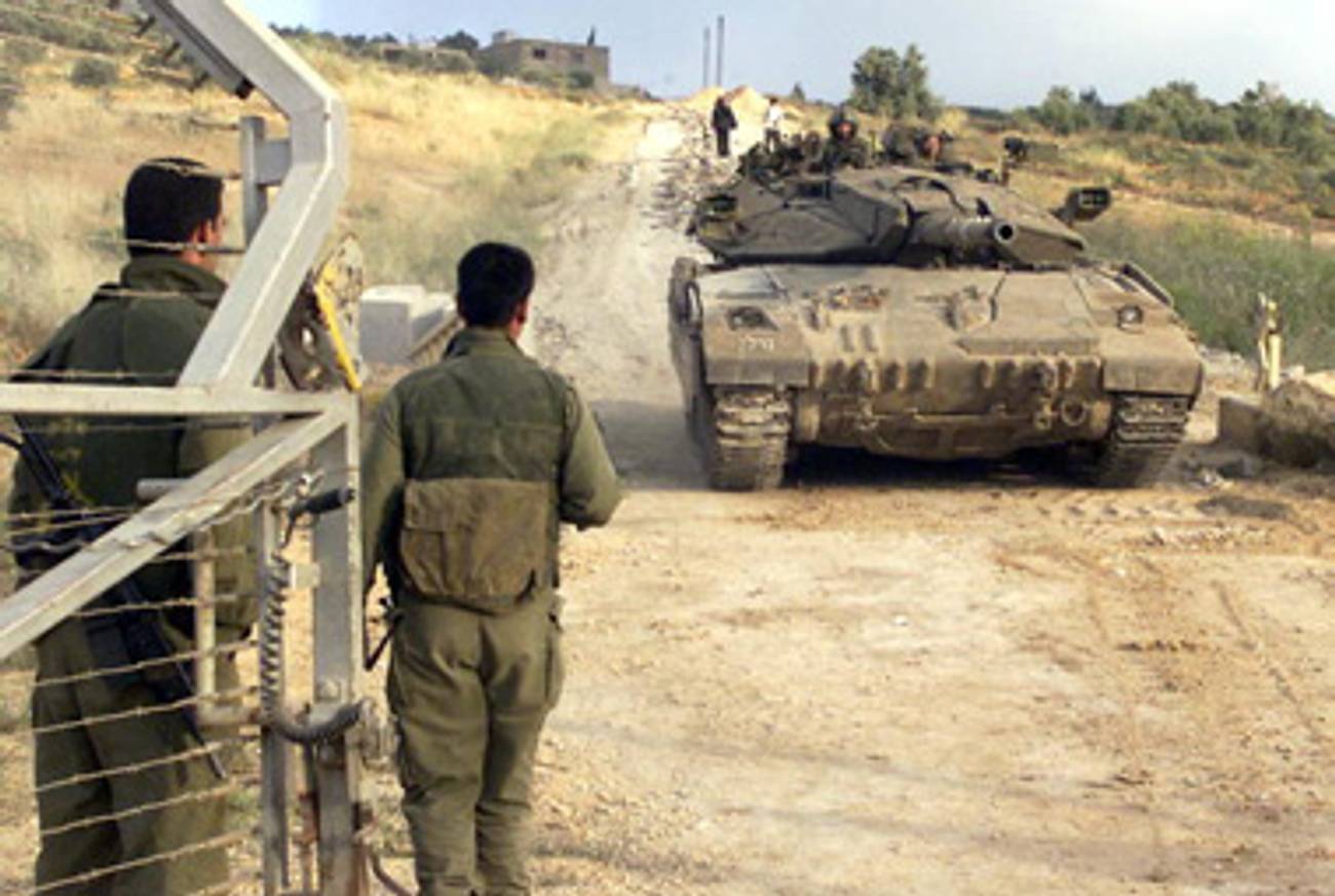 A person standing next to a tank

Description automatically generated