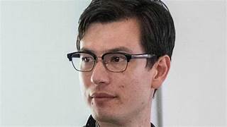 A person wearing glasses
Description automatically generated