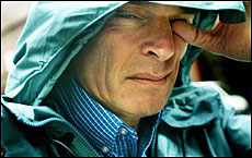 A person with a hood on his head

Description automatically generated