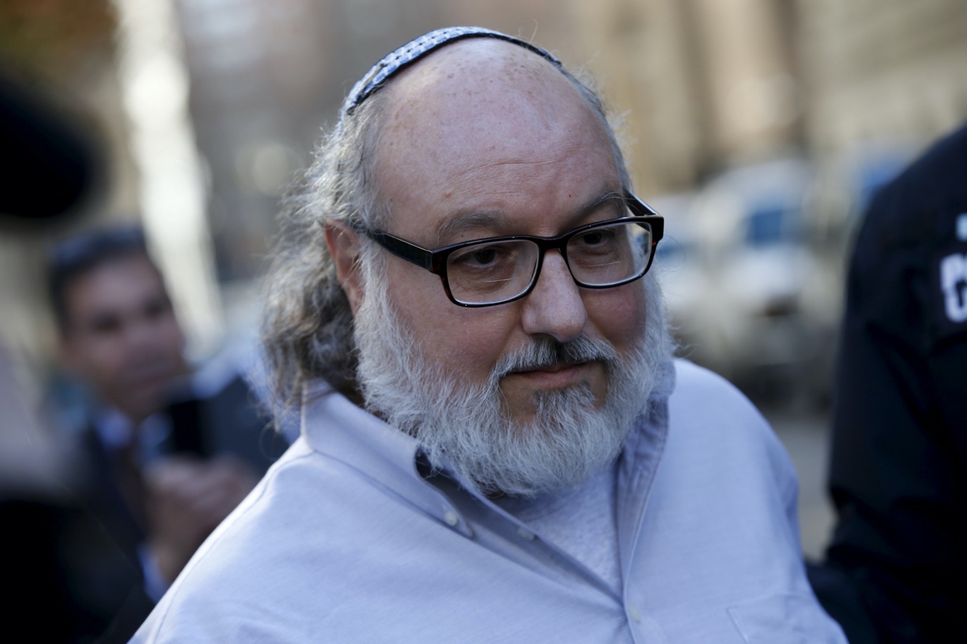 A person with a white beard and glasses

Description automatically generated