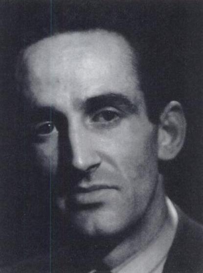 A person with dark hair and a dark shadow
Description automatically generated