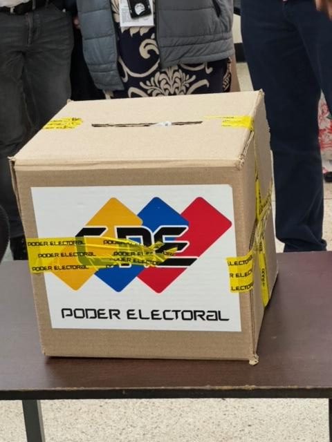 A cardboard box with yellow tape Description automatically generated