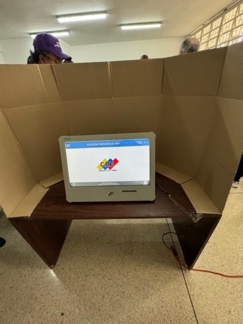 A computer in a cardboard box Description automatically generated