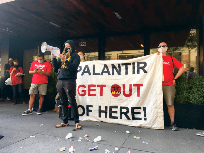 A group of people holding a banner Description automatically generated