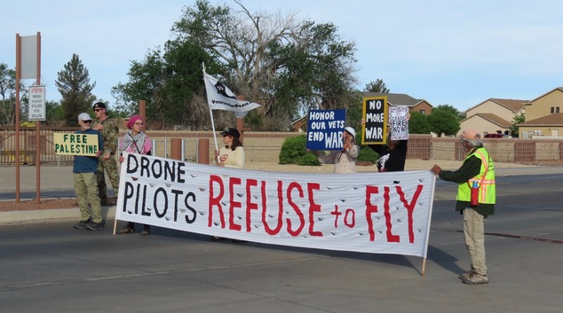 A group of people holding signs

Description automatically generated