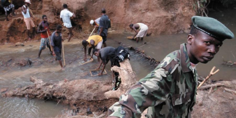 A group of people working in a muddy area

Description automatically generated
