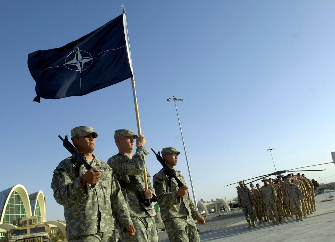 A group of soldiers holding a flag

Description automatically generated