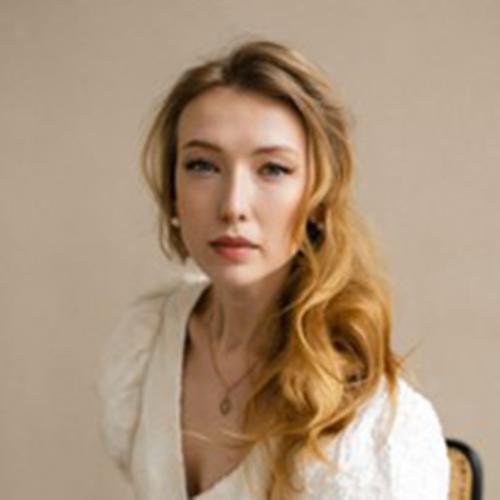 A person in a white dress

Description automatically generated