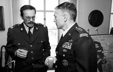 Generals Clark and Ćosić talking at a meeting