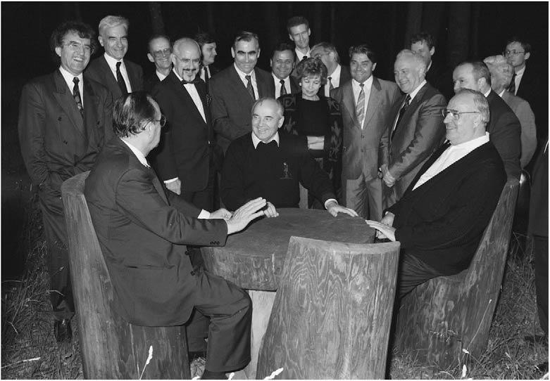 A group of men in suits around a table

Description automatically generated