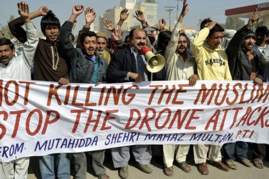 A group of people holding a banner

Description automatically generated