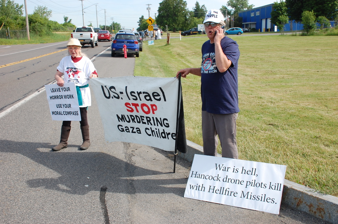 A group of people holding signs

Description automatically generated