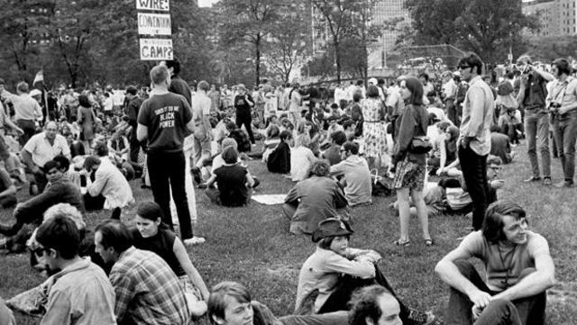 A group of people sitting on the grass
Description automatically generated