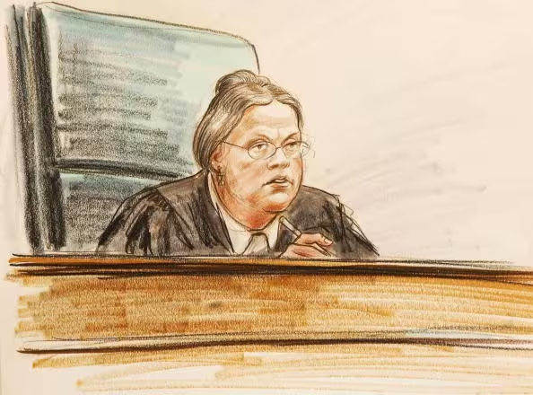 A judge sitting in a courtroom

Description automatically generated