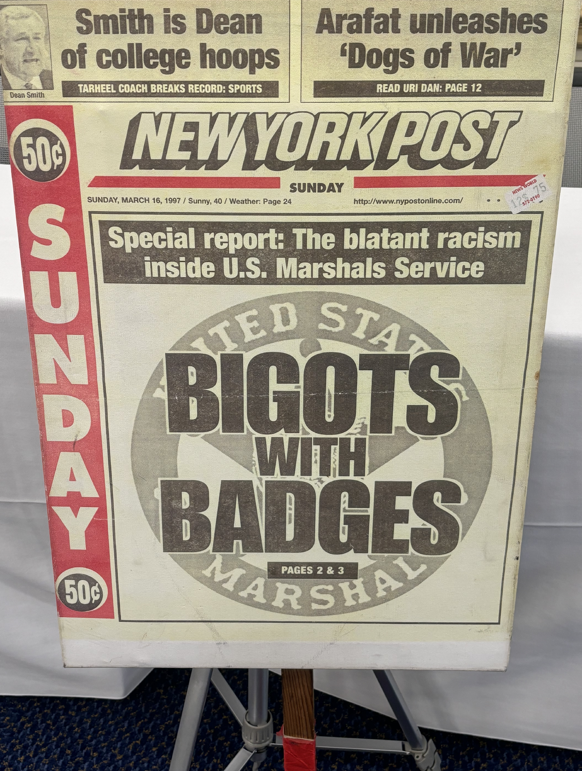 A newspaper on a stand
Description automatically generated
