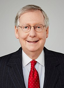 A person in a suit and tie

Description automatically generated