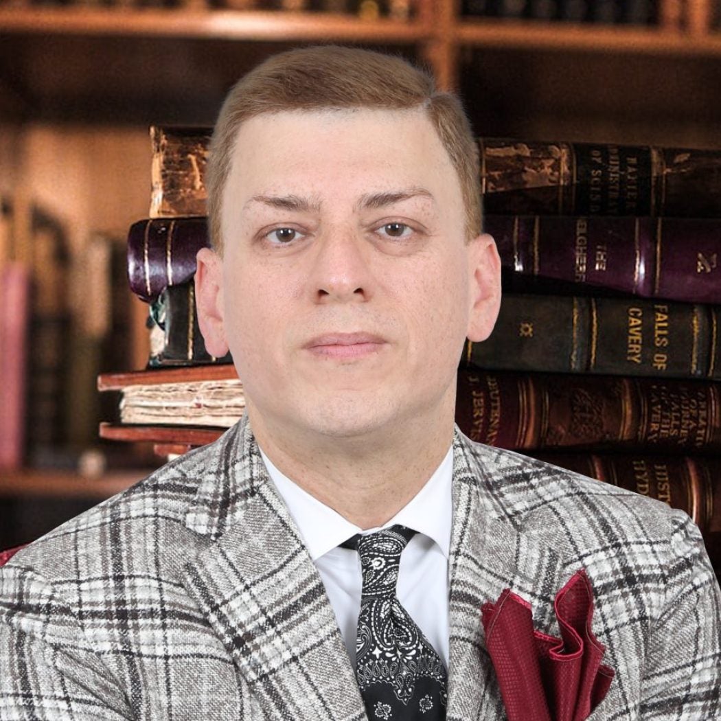 A person in a suit

Description automatically generated