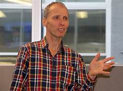 A person in plaid shirt

Description automatically generated