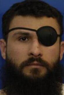 A person with a beard and eye patch

Description automatically generated