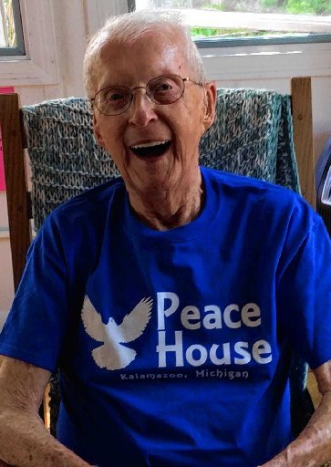 An old person wearing glasses and a blue shirt

Description automatically generated