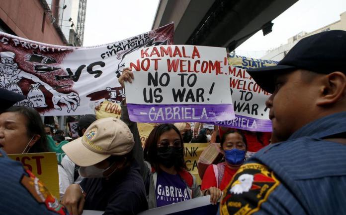 Protesters try to march closer to the Presidential Palace to protest the three-day official visit of US Vice President Kamala Harris in Manila, Philippines, Monday Nov. 21, 2022. 