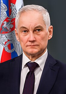 A person in a suit and tie

Description automatically generated