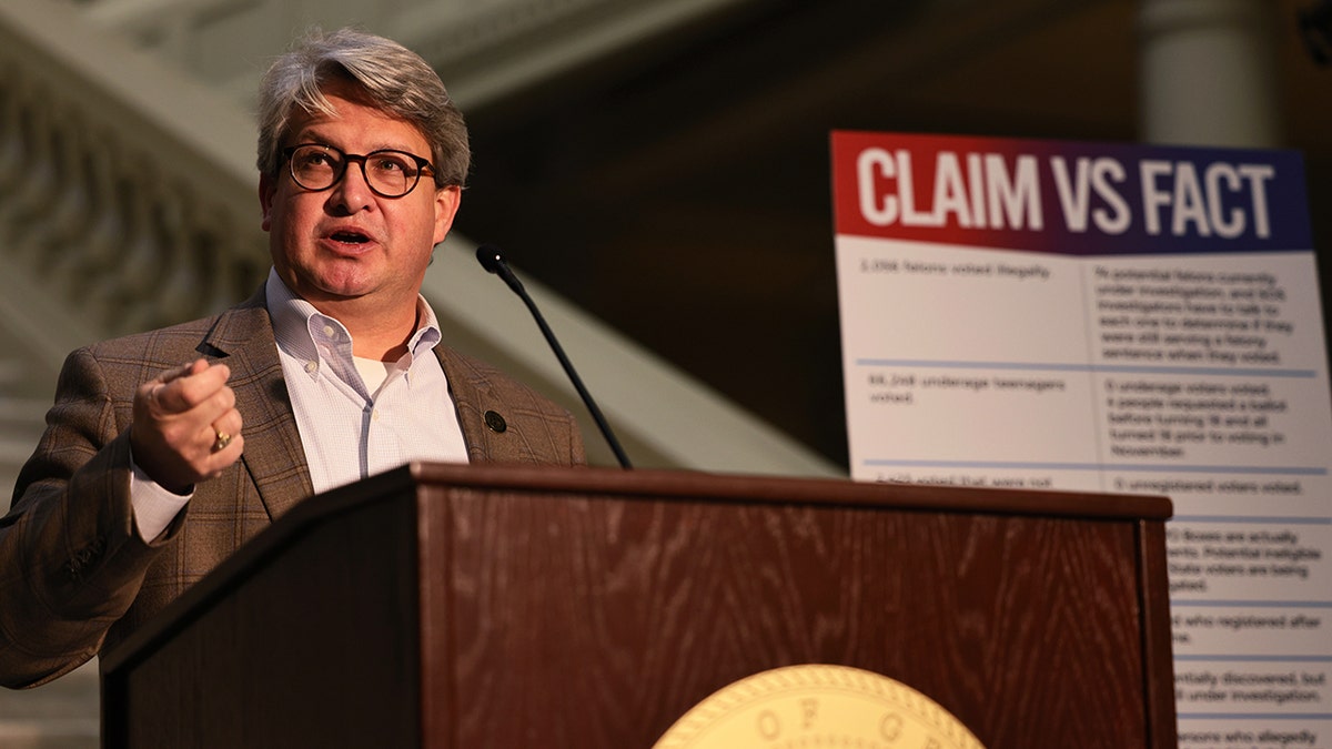 A person standing at a podium

Description automatically generated