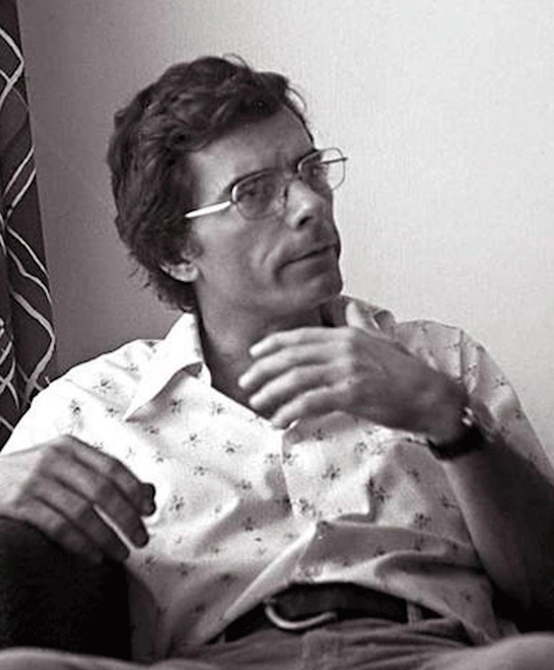 A person wearing glasses and a white shirt

Description automatically generated