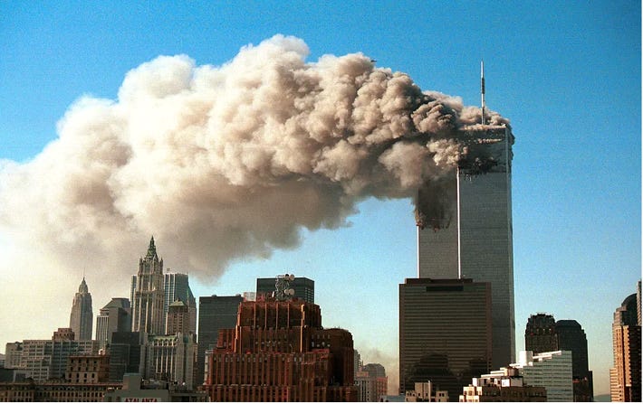 A tall building with smoke coming out of it

Description automatically generated
