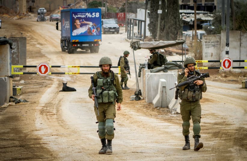 Israeli soldiers block the entrance to the village of Beita, in the West Bank on September 13, 2023, (photo credit: NASSER ISHTAYEH/FLASH90)
