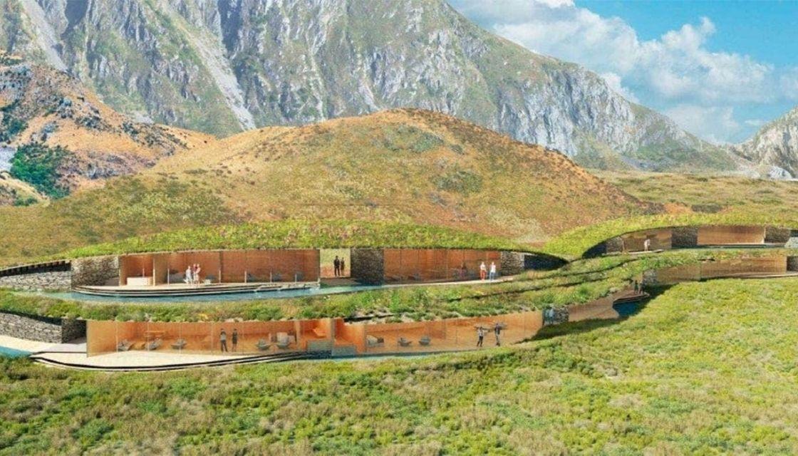 A green landscape with mountains and a building
Description automatically generated with medium confidence