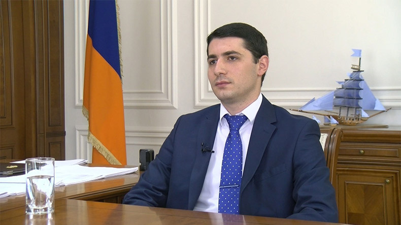 A person in a suit and tie
Description automatically generated