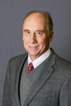 A person in a suit and tie

Description automatically generated