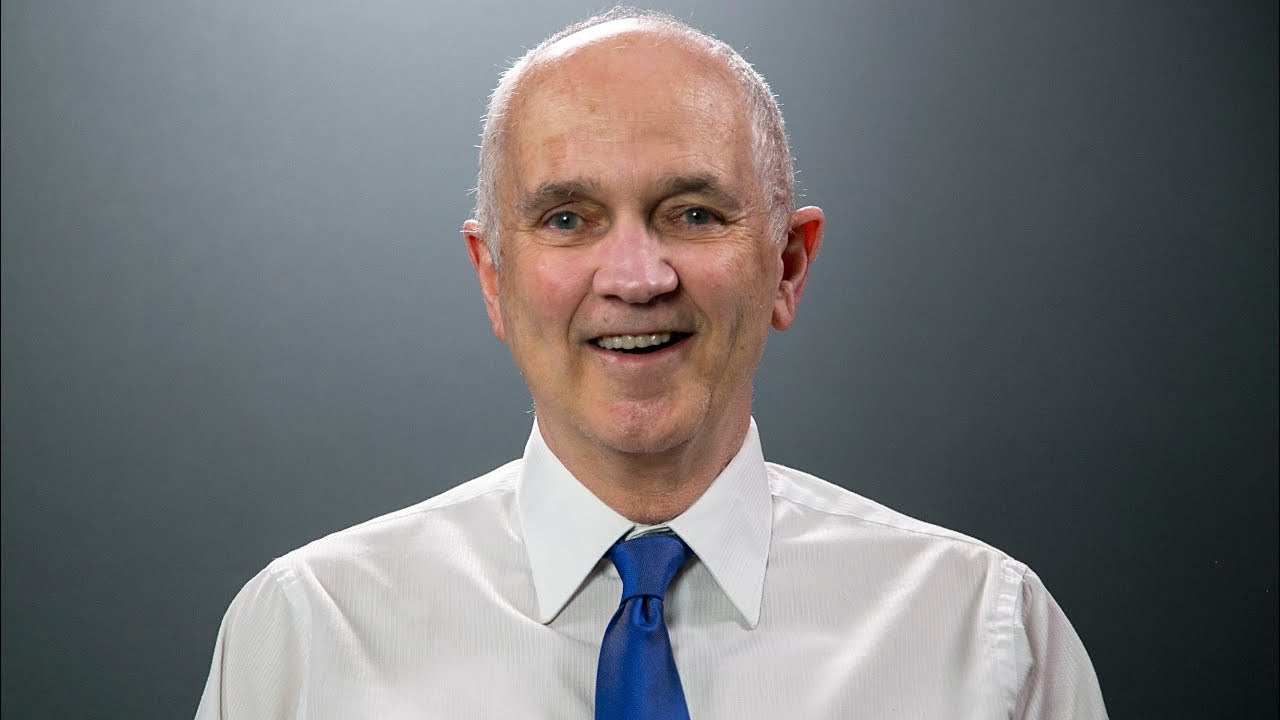 A person in a white shirt and blue tie

Description automatically generated