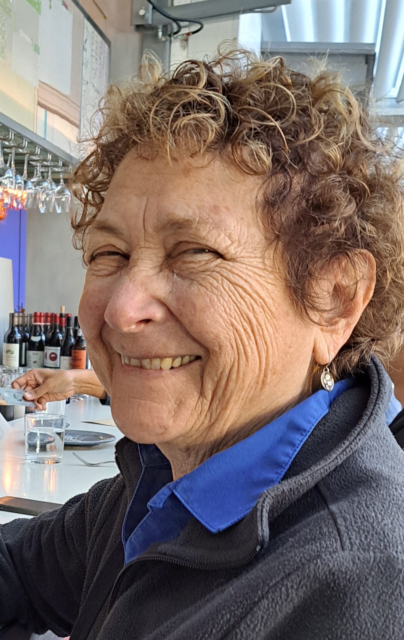 A person smiling at the camera

Description automatically generated