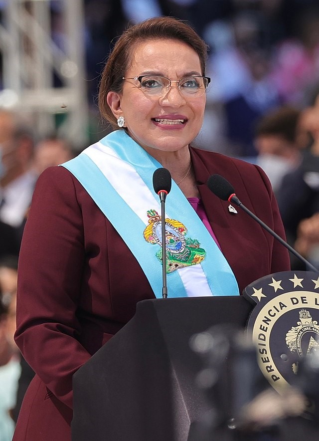 A person standing at a podium

Description automatically generated