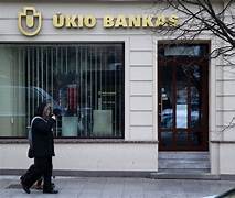 A person walking past a bank

Description automatically generated