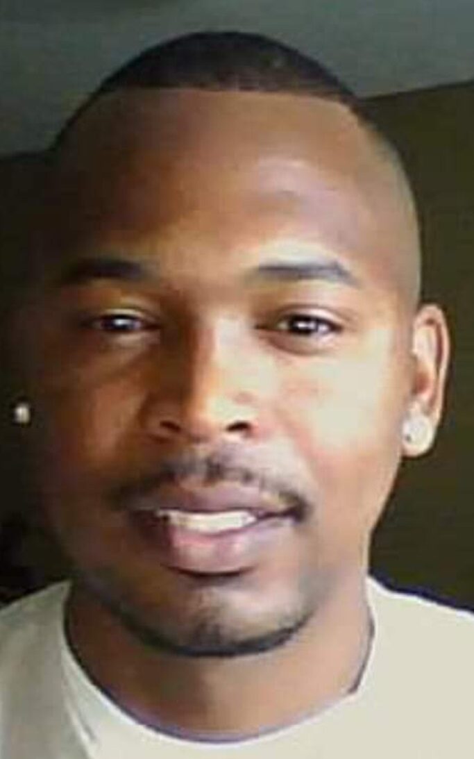 A person with a mustache and earring
Description automatically generated
