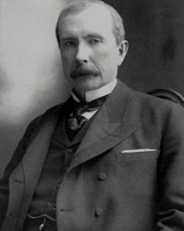 A person with a mustache sitting in a chair

Description automatically generated