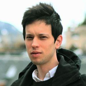 A person with dark hair wearing a black jacket

Description automatically generated