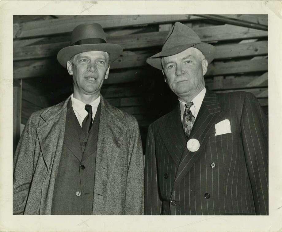 A couple of men in suits

Description automatically generated
