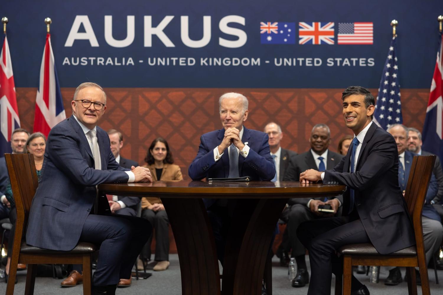 A group of men sitting at a table

Description automatically generated